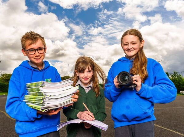 The students with copies of Parish Pages, a 48-page parish magazine featuring local stories, interviews, events and nostalgia.