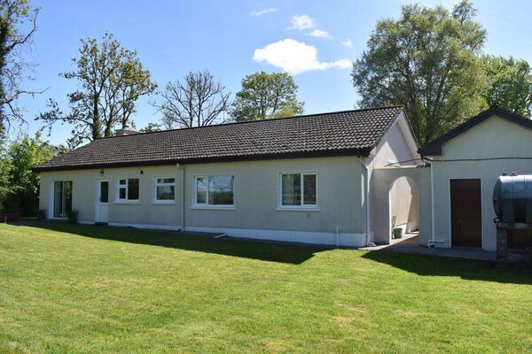 the property is set on a level site with mature trees and beautifully maintained lawns to the front and rear. the property is set on a level site with mature trees and beautifully maintained lawns to the front and rear.
