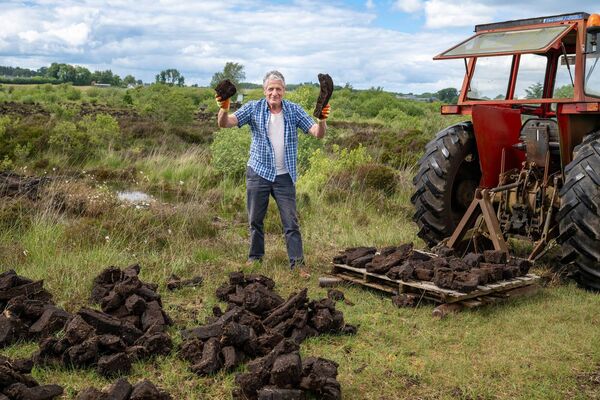 Denis Higgins making the most of the good weather, bringing home the turf in Tully bog. Pic: Breda Durr