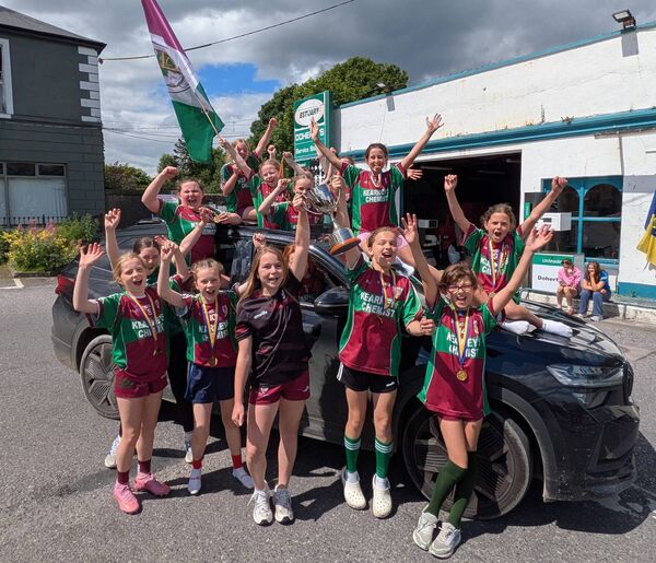 Community Games U-12s Girls Football County Champions celebrating their victory.