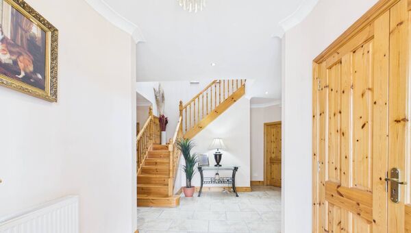 The breathtaking entrance hall is flooded with natural light and features decorative coving, a magnificent staircase and a feature skylight overhead. 