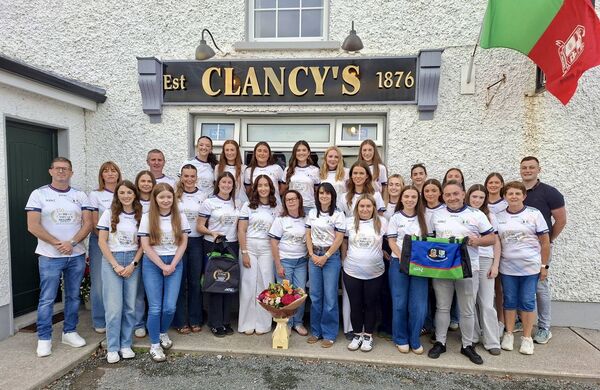 Ann and Michael McGonigle, Clancy’s Bar, Knockvicar, present kitbags and tops to the St. Michael’s/St. Ronan’s junior ladies’ football panel and management to mark 150 years in business.