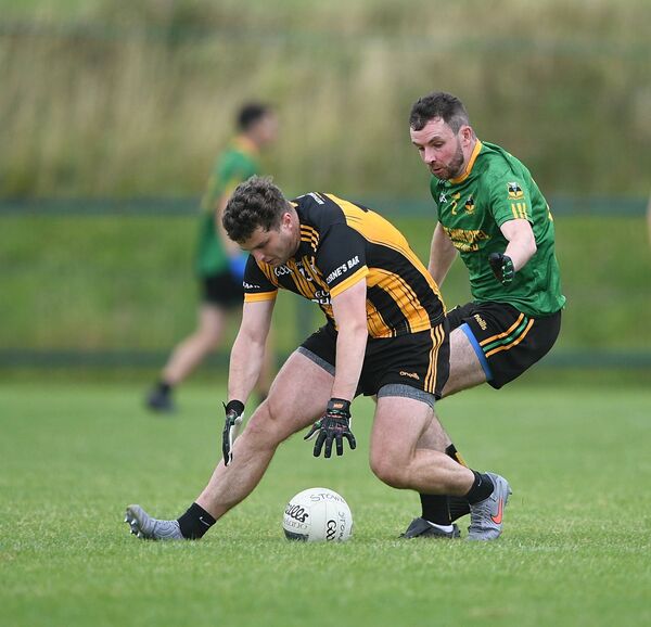 Strokestown forward Kevin Finn stoops to gather possession ahead of Michael Glaveys defender, Conor Ruane, during Sunday's senior football championship game in Enfield. Picture: Gerard O'Loughlin Strokestown forward Kevin Finn stoops to gather possession ahead of Michael Glaveys defender, Conor Ruane, during Sunday's senior football championship game in Enfield. Picture: Gerard O'Loughlin