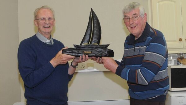 Canon Gerry Hanly, Boyle makes a presentation to the late Frank O'Mahony, on behalf of the Boyle Parish, in appreciation for his work in the parish down through the years. Pic. Mary Regan