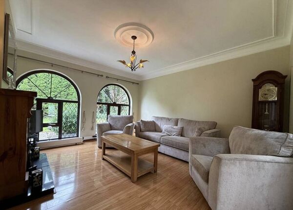 The bright and spacious sitting room features ceiling coving, wood flooring and a beautiful feature fireplace.