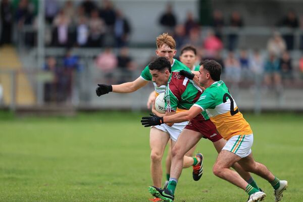Dara Curran tries to burst through the tackles of Jack Earley and Micheal Hussey during Saturday evening's senior football championship game between Castlerea St. Kevin's and Oran at O'Rourke Park. Picture: Bernie O'Farrell