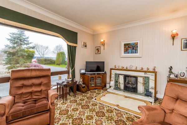 The generously sized sitting room has two large windows overlooking the beautifully maintained front garden. The generously sized sitting room has two large windows overlooking the beautifully maintained front garden.