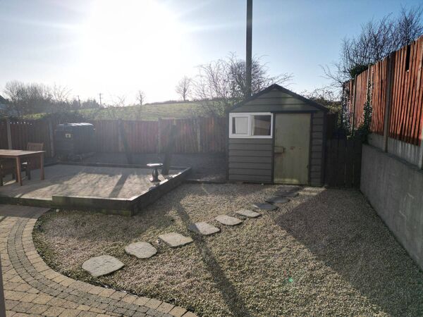 The rear garden features a detached metal- deck shed, providing valuable additional storage space. The rear garden features a detached metal- deck shed, providing valuable additional storage space.