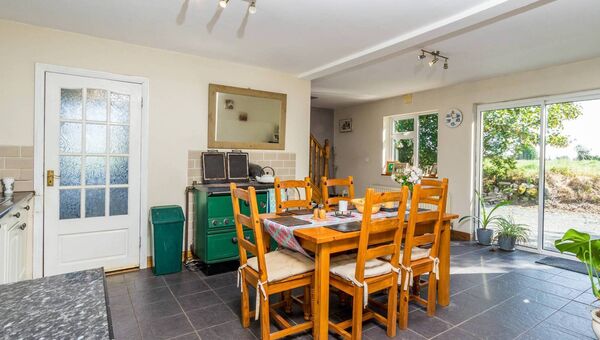 The light filled open plan kitchen/diner has double doors leading to the garden. The light filled open plan kitchen/diner has double doors leading to the garden.