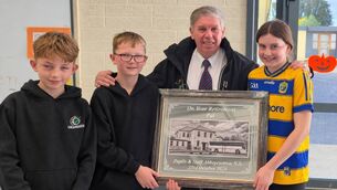 <p>Senior children from Abbeycartron NS, Elphin, Lauren, Aaron and Jonah presenting Pat with an engraved mirror.</p>