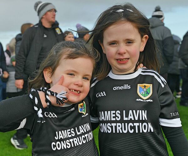Sisters Sophia and Ruby McEvoy supporting the Éire Óg intermediate footballers during their championship final success against Tulsk on Sunday last. 